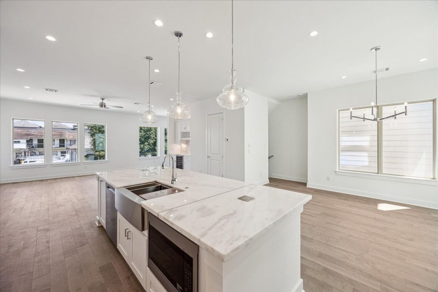 Island has a Microwave, Sink, Dishwasher and Cabinets.