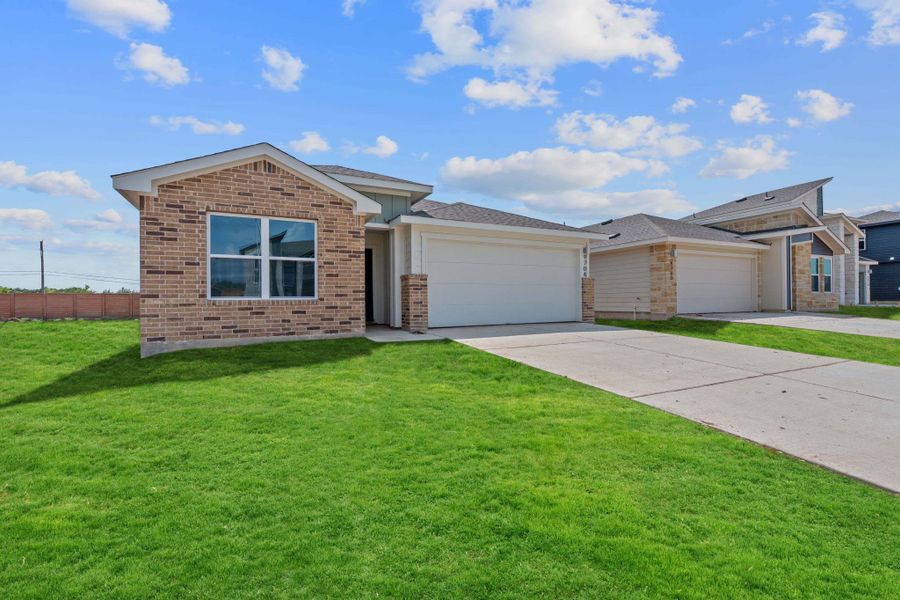 Single story home featuring driveway, a garage, and brick siding Single story home featuring driveway, a garage, and brick siding
