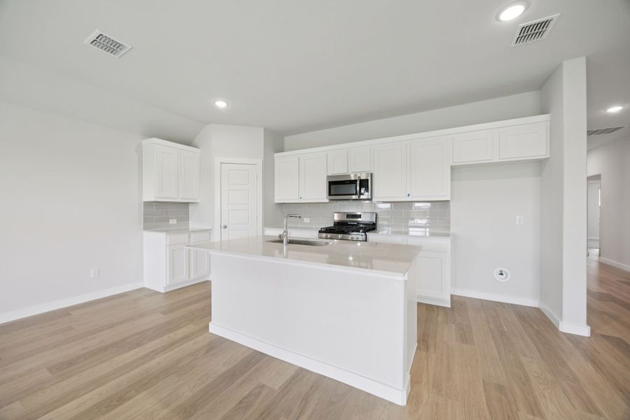 Kitchen in the Hadley home plan by Trophy Signature Homes – REPRESENTATIVE PHOTO
