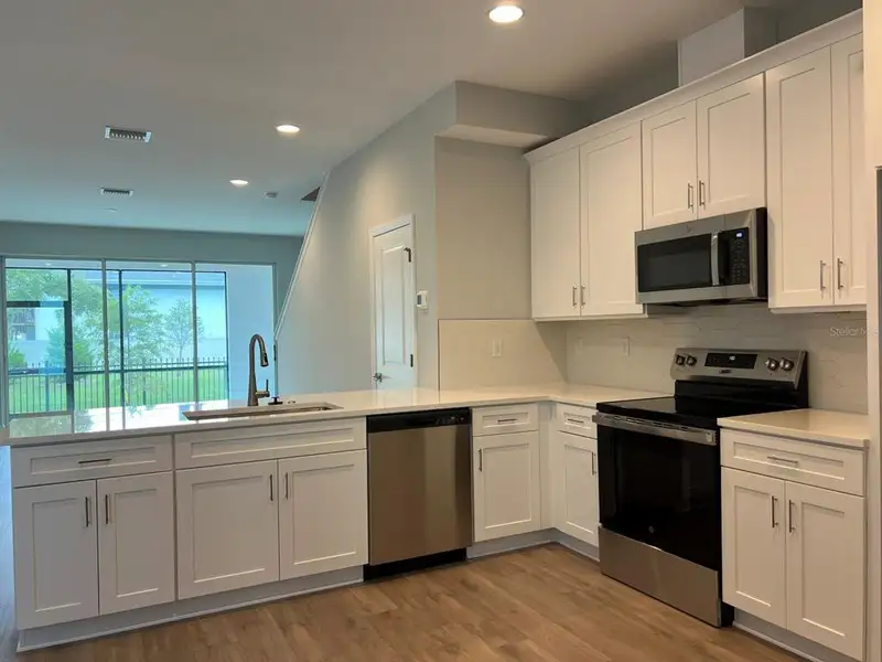 Furnished interior view inside a new home in The Towns At Long Bayou, Seminole (Image 8).
