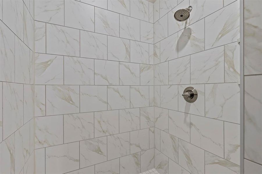 Bathroom featuring a tile shower