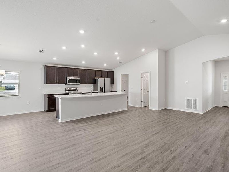 Enjoy a sunny, open living area with volume ceilings - Remy by Highland Homes Enjoy a sunny, open living area with volume ceilings - Remy by Highland Homes