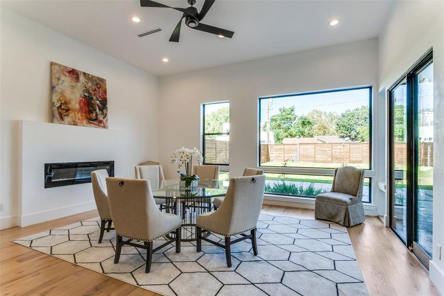 Dining room featuring light hardwood / wood-style flooring, a healthy amount of sunlight, and ceiling fan