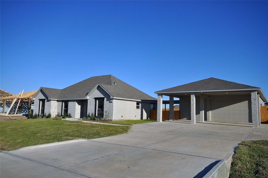 Front exterior of a new home in Pedregal, League City, TX, highlighting curb appeal (Image 23).