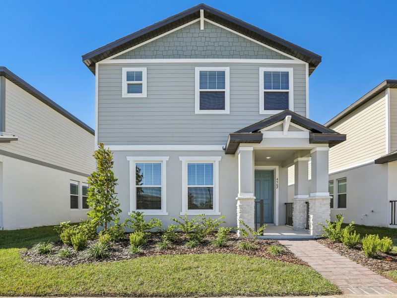 Front exterior of a new home in The Meadow at Crossprairie Bungalows, St. Cloud, FL, highlighting curb appeal (Image 1). Front exterior of a new home in The Meadow at Crossprairie Bungalows, St. Cloud, FL, highlighting curb appeal (Image 1).