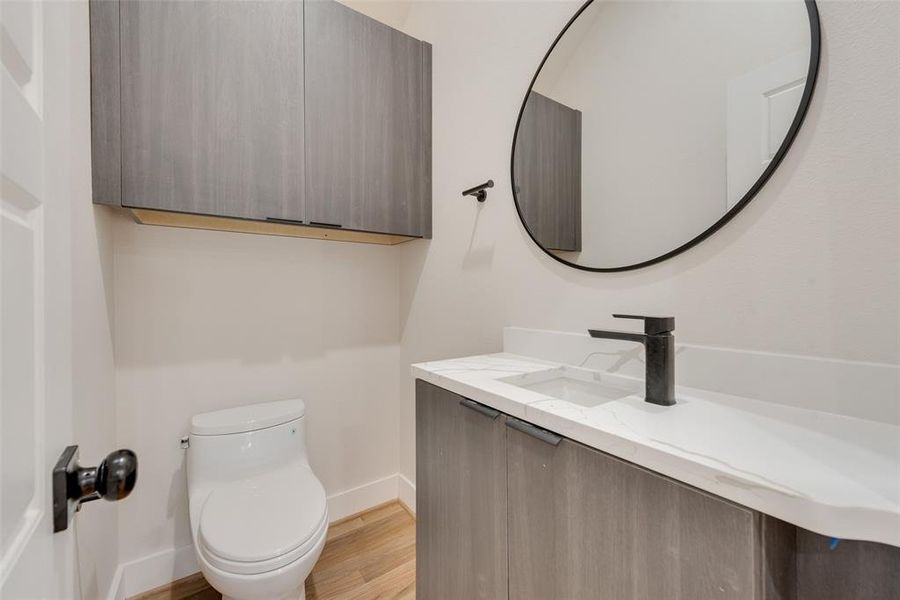 Bathroom with vanity, toilet, and hardwood / wood-style flooring