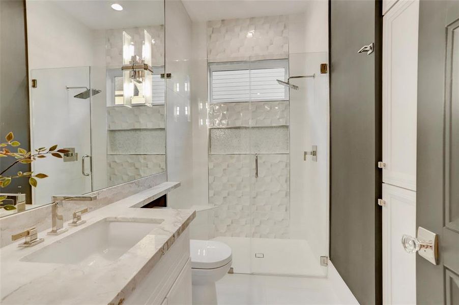 Bath #4/Powder:  On first floor adjacent to the Study/#6 bedroom is a full bath with remarkable Storage, walk-in shower, and tile selections integrated with kitchen.  Note the mixed metals on both plumbing and lighting fixtures.