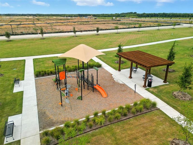 Community jungle gym with a yard and a patio