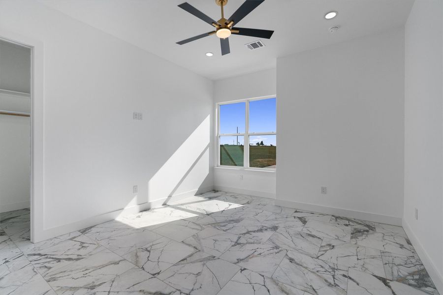 A pristine interior with stylish tiled flooring and an inviting window view. A pristine interior with stylish tiled flooring and an inviting window view.
