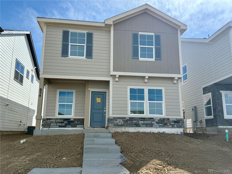 Front exterior of a new home in Sky Ranch – Uptown Collection, Watkins, CO, highlighting curb appeal (Image 1).