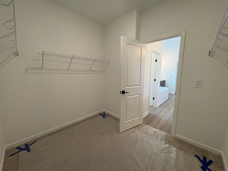 Primary Walk-In Closet featuring AW Collection® Oxford - Spacious simplicity designed for ease. Primary Walk-In Closet featuring AW Collection® Oxford - Spacious simplicity designed for ease.