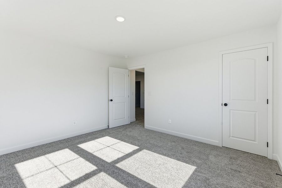 A hallway with white doors.