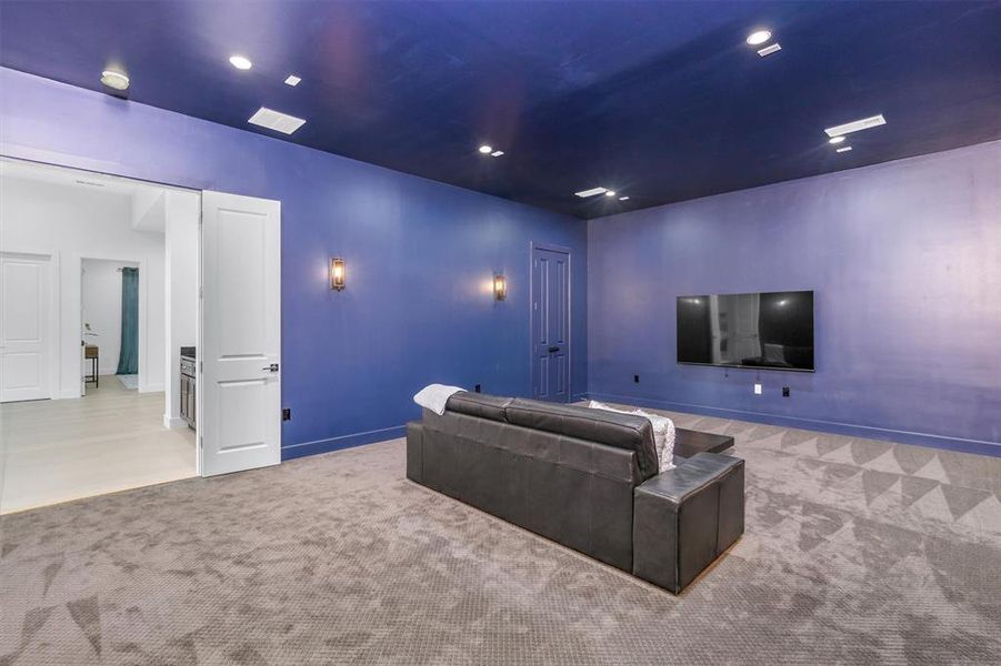 Carpeted cinema with recessed lighting