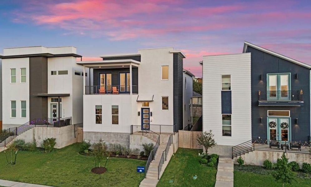 Modern home with a balcony and a front yard