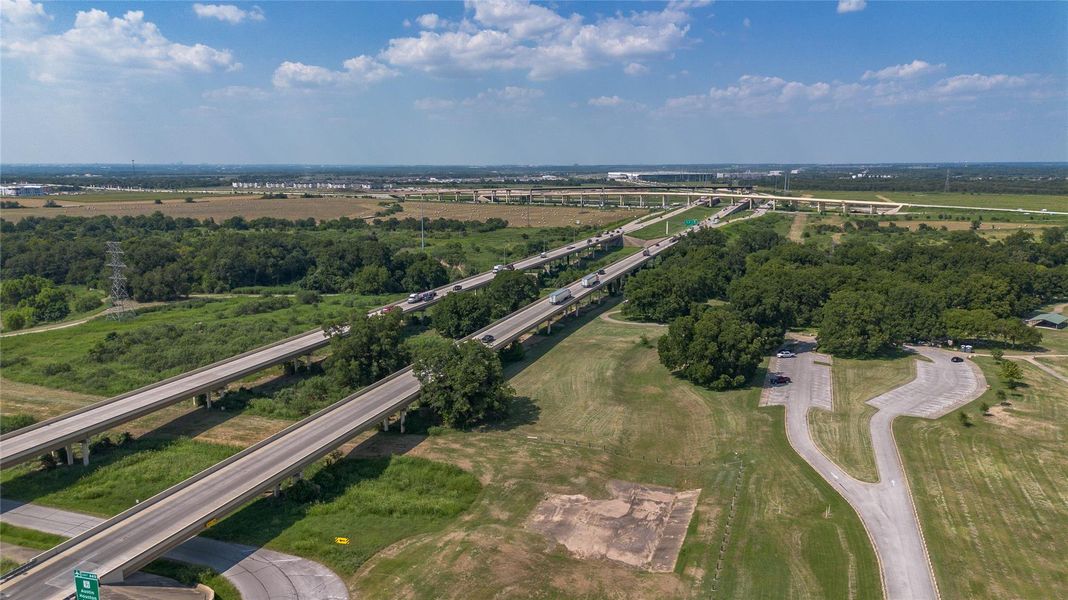 Aerial view of property's location featuring a highway and a tree filled landscape Aerial view of property's location featuring a highway and a tree filled landscape