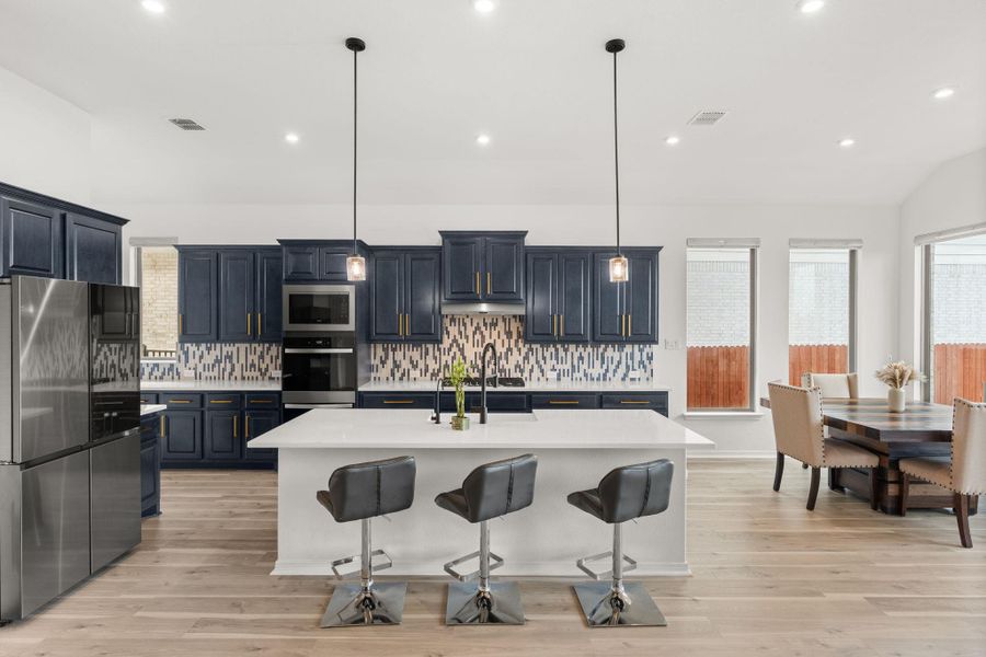 A well-appointed kitchen features a large island and ample cabinet space, perfect for culinary endeavors and entertaining. A well-appointed kitchen features a large island and ample cabinet space, perfect for culinary endeavors and entertaining.