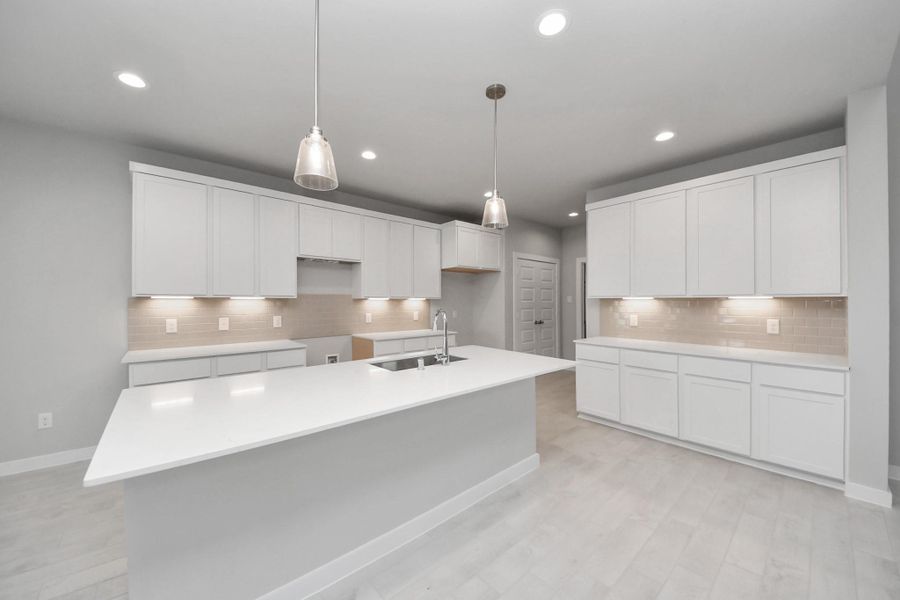 The open concept effortlessly connects the kitchen to the expansive family room, forming a perfect hub for gatherings. This seamless flow creates an inviting space where cooking and socializing come together harmoniously.