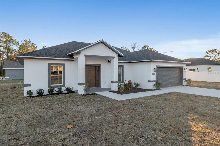 Front exterior of a new home in , Ocala, FL, highlighting curb appeal (Image 27).