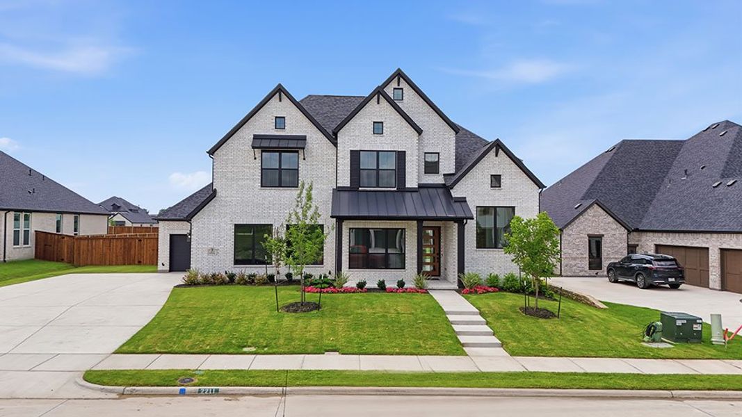 Front exterior of a new home in Winding Creek, Rockwall, TX, highlighting curb appeal (Image 2). Front exterior of a new home in Winding Creek, Rockwall, TX, highlighting curb appeal (Image 2).
