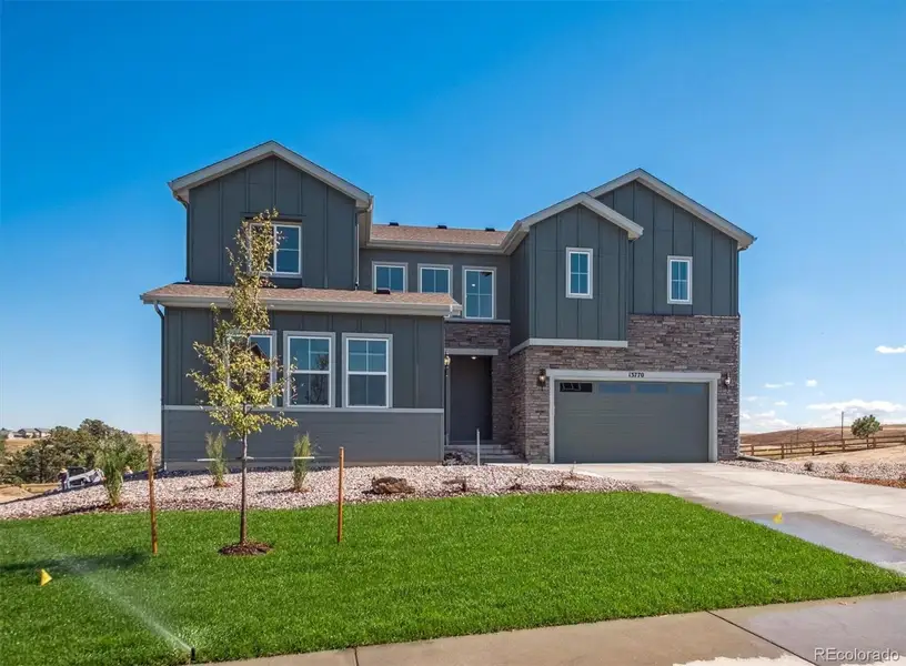 Front exterior of a new home in Trails at Smoky Hill, Parker, CO, highlighting curb appeal (Image 2).