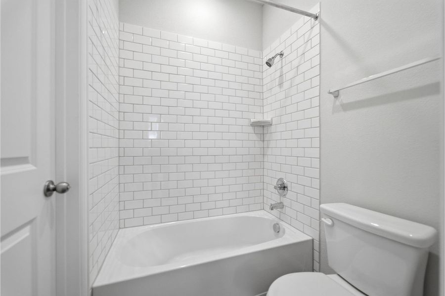 Full bath featuring toilet and shower / washtub combination