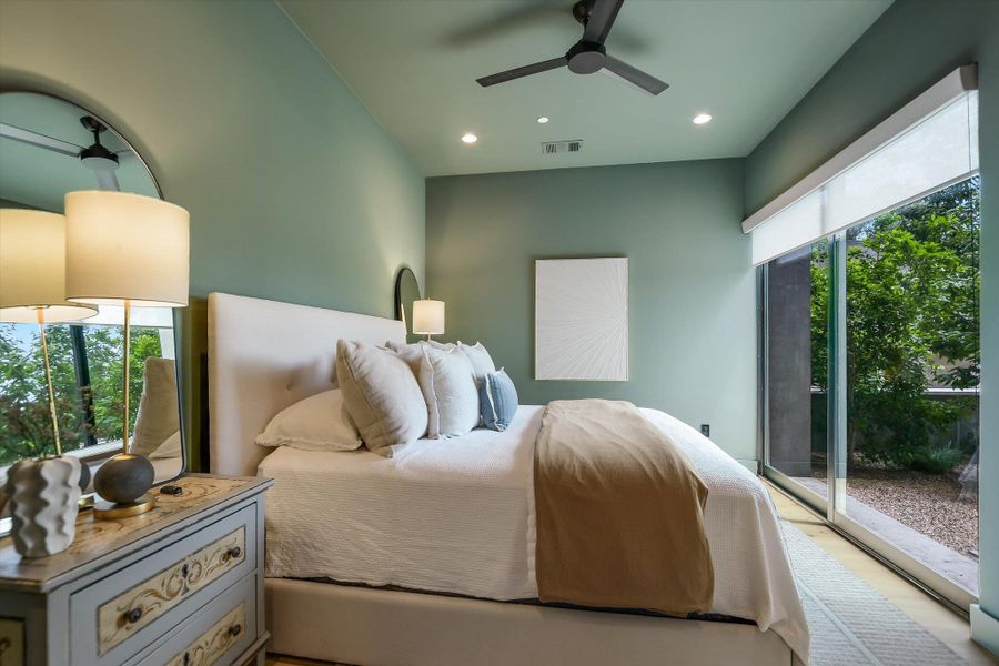 Room featuring a ceiling fan with integrated lighting, recessed ceiling lights, and a full glass sliding door