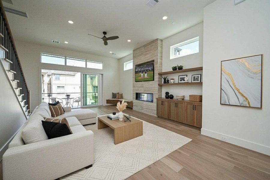 Living Area with 3 Panel Door opening to large balcony. Virtually Staged.