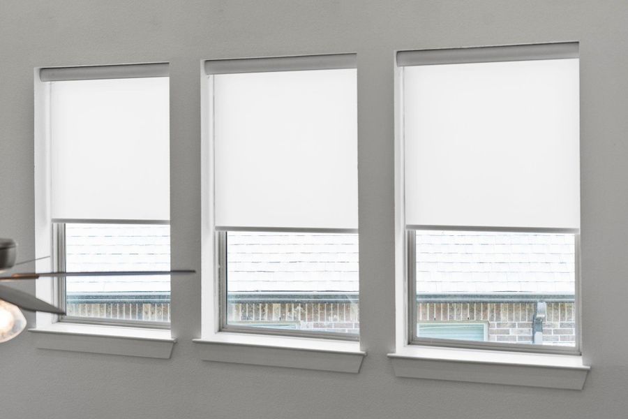 Motorized shades added to windows on second level facing living area Motorized shades added to windows on second level facing living area