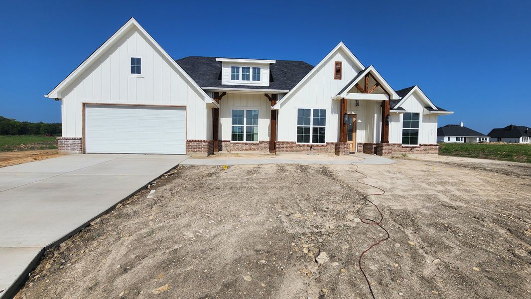 Front exterior of a new home in Paloma Ranches, Justin, TX, highlighting curb appeal (Image 1). Front exterior of a new home in Paloma Ranches, Justin, TX, highlighting curb appeal (Image 1).