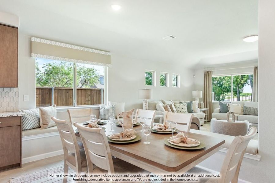 Open-concept dining area with wood table, white chairs, and living room visible in background