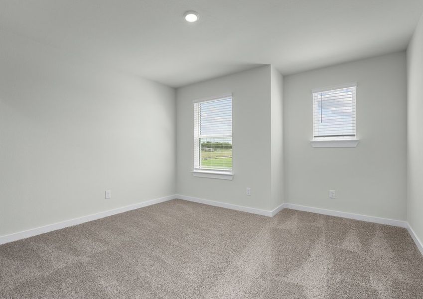 Large secondary bedroom with two windows for natural light.