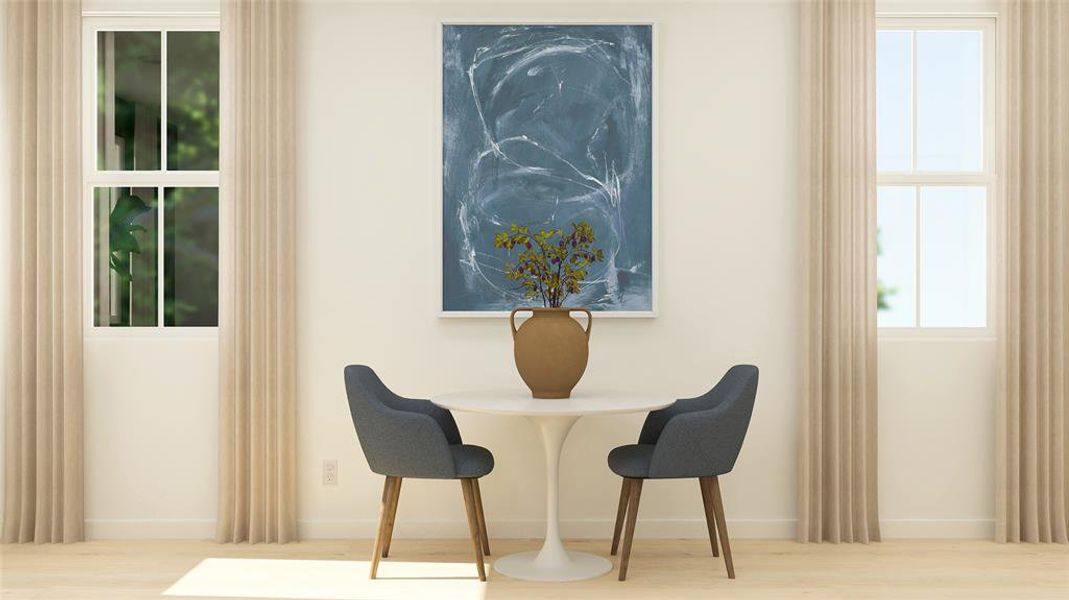 Dining area with wood finished floors and plenty of natural light