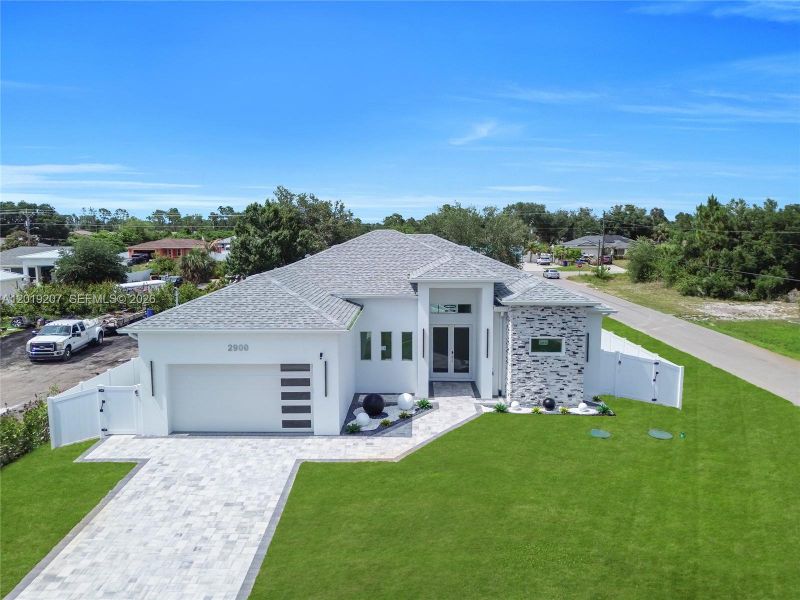 Front exterior of a new home in , Lehigh Acres, FL, highlighting curb appeal (Image 2). Front exterior of a new home in , Lehigh Acres, FL, highlighting curb appeal (Image 2).
