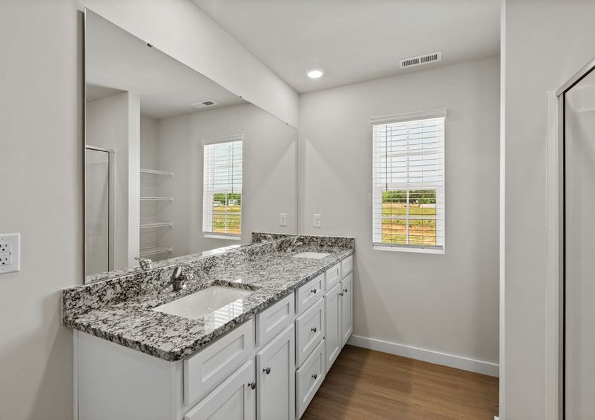 The master bathroom has a glass-enclosed shower
