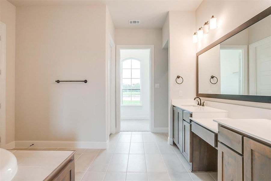 Bathroom with vanity, ceiling fan, and tile patterned floors