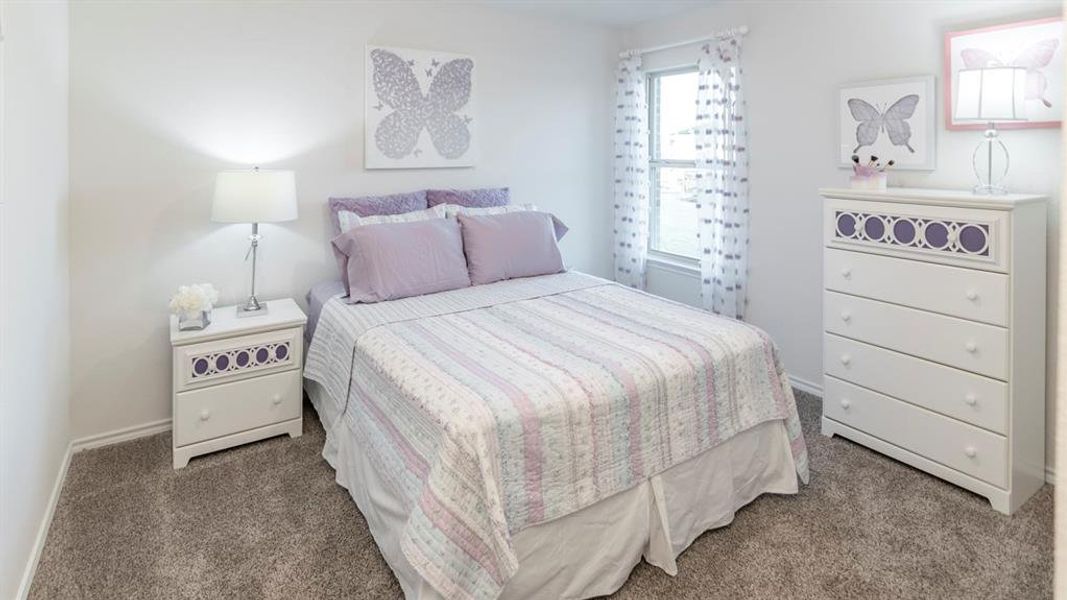 Bedroom featuring baseboards and dark colored carpet