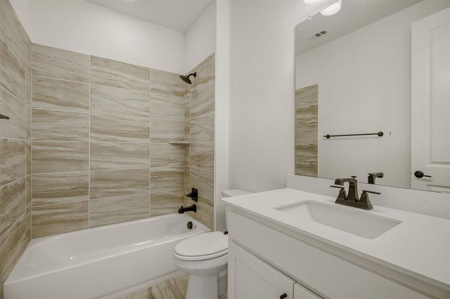 Bathroom with shower / bathtub combination and vanity