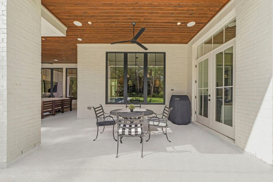 The custom doors and windows pair perfectly with the painted white brick for a clean and contemporary aesthetic. The custom doors and windows pair perfectly with the painted white brick for a clean and contemporary aesthetic.