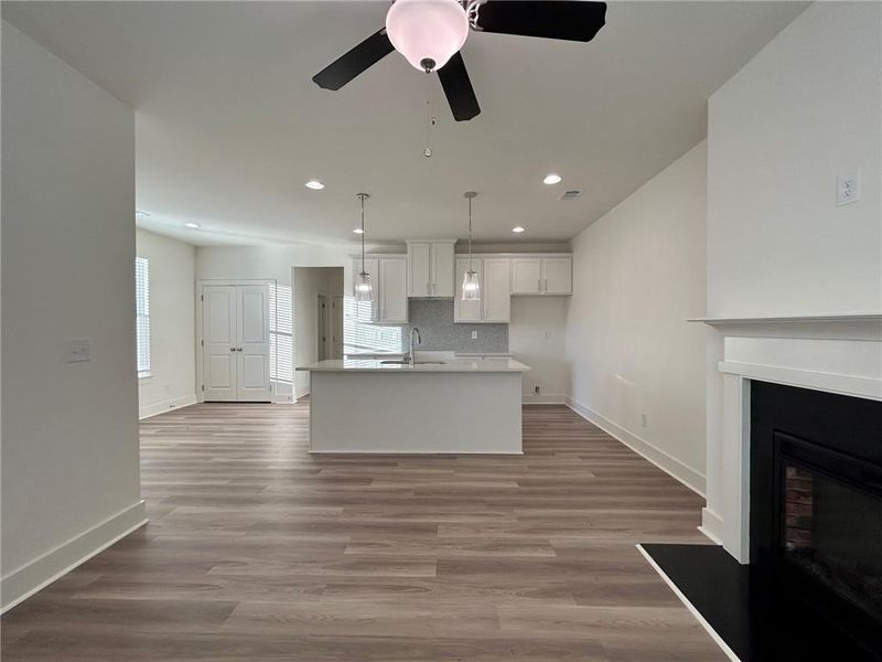 Kitchen with a center island with sink, plenty of natural light, and white cabinets