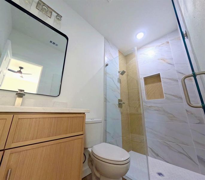 Full bathroom featuring a shower stall and vanity Full bathroom featuring a shower stall and vanity