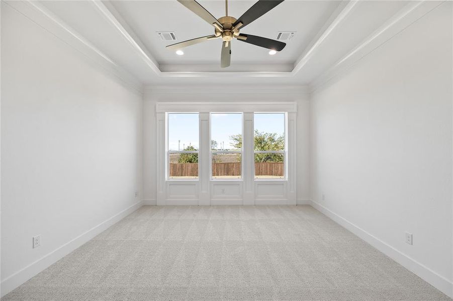 Unfurnished room featuring light colored carpet, a ceiling fan, a raised ceiling, and recessed lighting Unfurnished room featuring light colored carpet, a ceiling fan, a raised ceiling, and recessed lighting