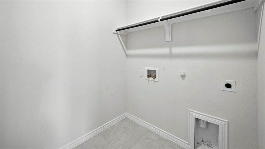 Laundry room with hookup for a gas dryer, hookup for a washing machine, and electric dryer hookup Laundry room with hookup for a gas dryer, hookup for a washing machine, and electric dryer hookup