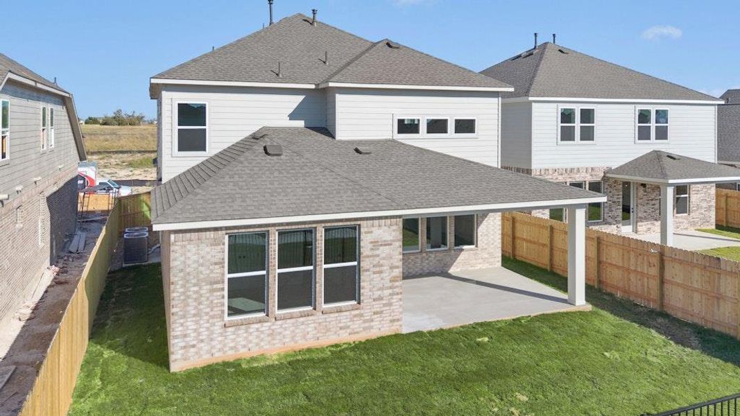 Back of property with roof with shingles, a patio, a fenced backyard, and brick siding
