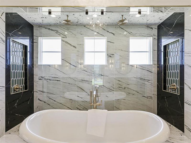 Bathroom featuring tile walls and shower with separate bathtub