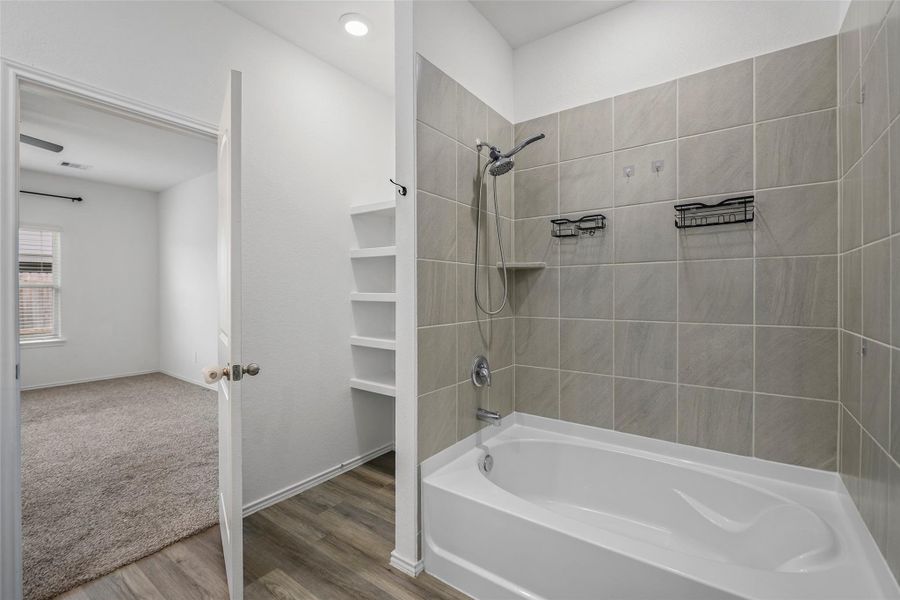 Tiled tub/shower combo with built-in shelving Tiled tub/shower combo with built-in shelving