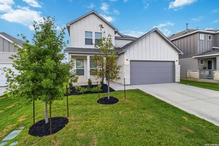 Front exterior of a new home in Davis Ranch, Helotes, TX, highlighting curb appeal (Image 2). Front exterior of a new home in Davis Ranch, Helotes, TX, highlighting curb appeal (Image 2).