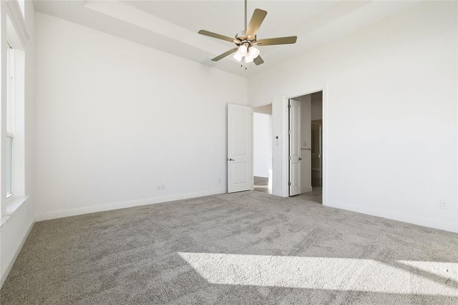 Unfurnished bedroom featuring carpet and a ceiling fan Unfurnished bedroom featuring carpet and a ceiling fan
