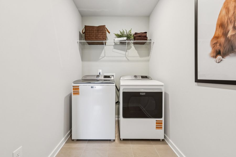 A washing machine and dryer in a room. A washing machine and dryer in a room.