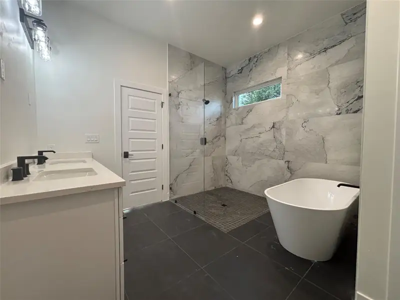 Luxurious bathroom retreat features a spacious walk-in shower and a free-standing soaking tub. Luxurious bathroom retreat features a spacious walk-in shower and a free-standing soaking tub.