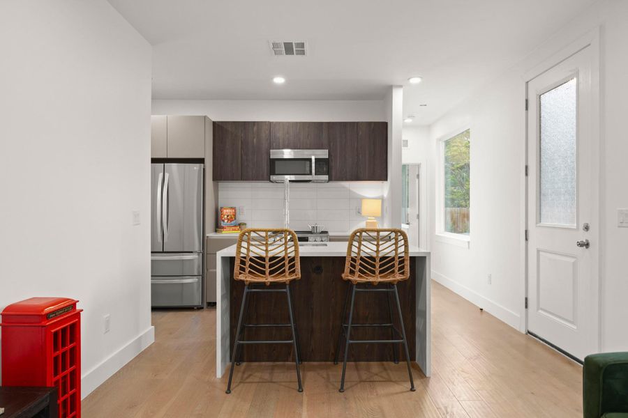 Open-concept kitchen with light wood-finish flooring